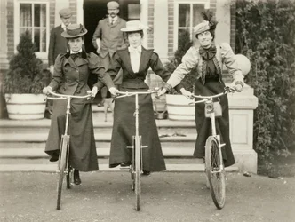 Three women on bicycles, early 1900s